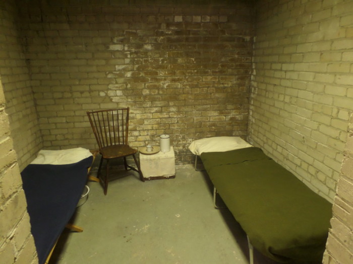 Doing Time: Above, Troy Township’s original jail cell, dressed to look similar to how it may have in the early days.